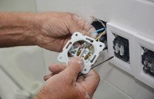 An Electrician Is Installing, Adding New Electrical Socket, Connecting Power Socket Outlet, Wires While Home Renovating.