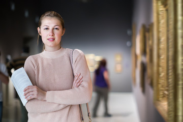 Wall Mural - Nice girl holding guide book in museum