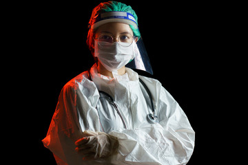 Women doctor wearing protective suit for corona virus or Covid-19 protection. Hazmat suit, face shield, gloves, mask, stethoscope.