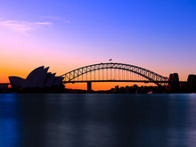 Panoramic View Of Sydney Harbour With All The Vibrant Colours On A Orange And Blue Sunset Afternoon 