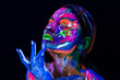 © Artem Zakharov - Body art glowing in ultraviolet light. Body art on the body and hand of a girl glowing in the ultraviolet light