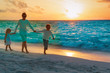 © nadezhda1906 - father with son and daughter walk on beach at sunset