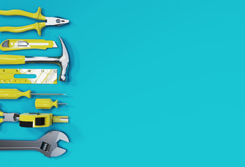 Many yellow hand tools on blue background, there is space for your ad.