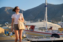 Fashionable Beautiful Girl Teenager Walking On Pier, Moored Yachts In Bay