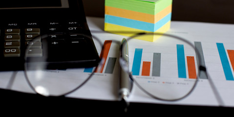 Poster - top view of business chart on white table with pen and calculator