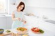 © deagreez - Photo of beautiful cheerful housewife enjoy hobby cooking family recipe dinner pizza add final last ingredient before putting in oven wear t-shirt apron standing modern kitchen indoors