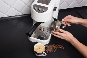 girl make cappuccino on white espresso coffee machine on modern kitchen