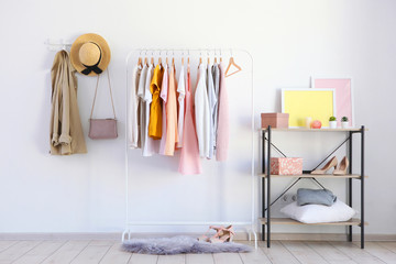 Wall Mural - fashionable clothes on a rack in a bright interior of the wardrobe room