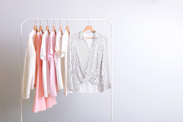 Wall Mural - fashion clothes on a rack in a light background indoors. place for text