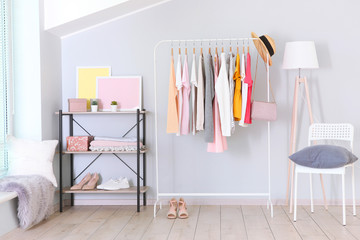 Wall Mural - fashionable clothes on a rack in a bright interior of the wardrobe room
