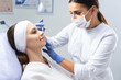 Smiling Caucasian lady getting a beauty injection