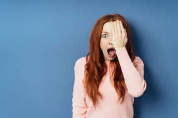 Canvas Print - Young woman gasping in astonishment