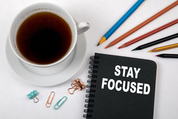 Wall Mural - STAY FOCUSED concept. Black notebook and office supplies