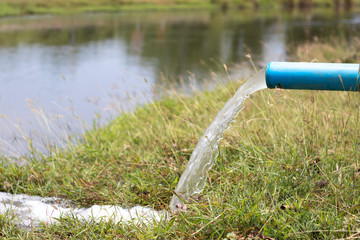 The water that flows out of the pipe into the natural water source.