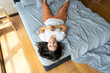 © Kate - Beautiful young brunette girl fooling around on the bed. View from above. Good mood
