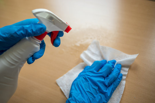 cleaning home table sanitizing office table surface with disinfectant spray bottle washing surfaces 