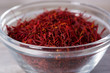 Close up on spice glass with red saffron on cutting board