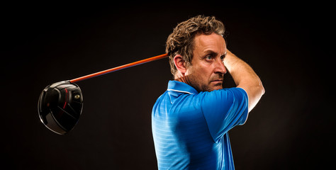 Wall Mural - Portrait of a golf player perfecting the swing isolated on dark background, banner image