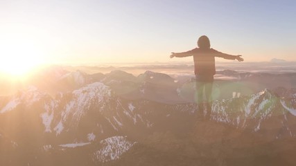 Wall Mural - Fantasy Adventure Composite with a Girl on top of a Rock Cliff with Beautiful Canadian Mountain Nature Landscape in Background during Sunset or Sunrise. 2.5D Parallax