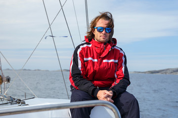 Wall Mural - A yachtsman on the fishing boat in open sea in Norway