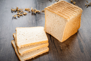 Fresh bakery, sliced bread on a wooden backround