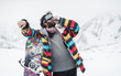 © guruXOX - Snowboarder with energy drink enjoying, against background of snowy peaks