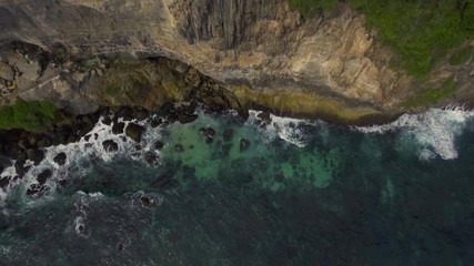 Wall Mural - Top view of rocks and waves.