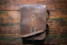 Old Retro Brown Leather Bag On The Table Flat Lay Background.