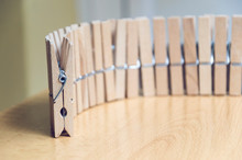 Group Of Wood Clothespins Arranged In Line
