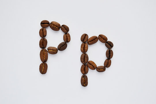 letters p made of coffee beans on the white background