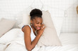 © Alexandr - beautiful young african woman sleeping on a white bed