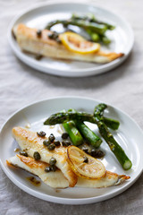 Wall Mural - Lemon sole with butter and capers sauce and asparagus