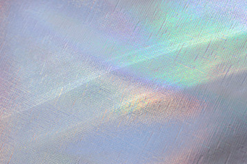 Blurred light rainbow holographic background with bright rays daylight.