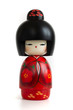 Kokeshi doll in red kimono. Still-life photo (taken on studio with white background and softbox) of a Japanese traditional doll isolated on white.