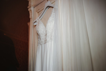 Poster - photo of a wedding dress hanged on a closet