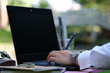 Poster - businessman using his laptop and phone at work and space for text