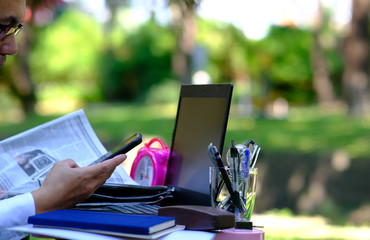 Poster - Businessman working with laptop computer and using his phone outdoors