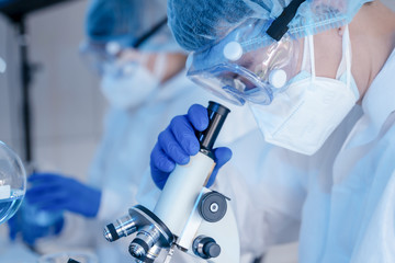 Wall Mural - biochemical research scientist team working with microscope for coronavirus vaccine development in p