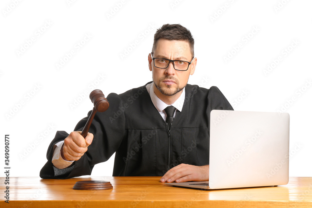 Strict male judge at table on white background
