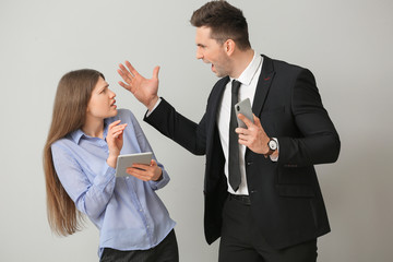 Poster - Angry boss scolding his secretary on light background