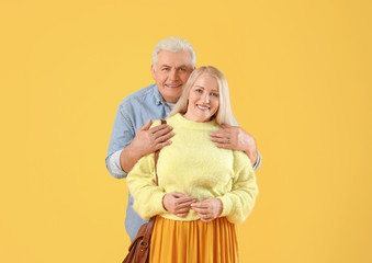 Sticker - Portrait of happy elderly couple on color background