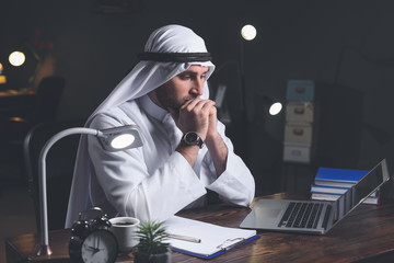 Poster - Arab businessman working in office late at night