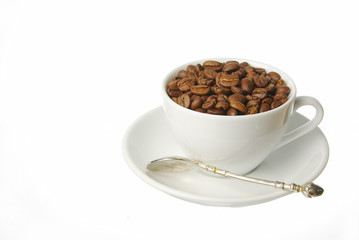 White cup on a saucer with sprinkled coffee grains. Isolated on white.