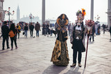 Fototapeta Sawanna - Portrait of a couple with beautiful masks in Venice, Italy