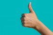 © NatBud - thumb up sign. sign 'class' on a turquoise background. Hand shows thumb up