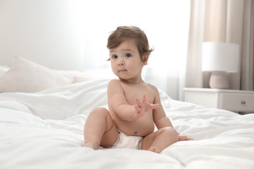 Poster - Cute little baby in diaper on bed