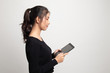 © halfbottle - Young Asian woman with a computer tablet.