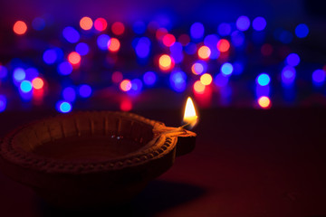 Wall Mural - Diya lamps lit with bokeh background during diwali celebration