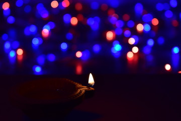 Wall Mural - Diya lamps lit with bokeh background during diwali celebration