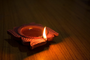 Wall Mural - Diya lamps lit with bokeh background during diwali celebration